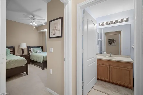 a en suite bathroom with a double vanity sink and a mirror