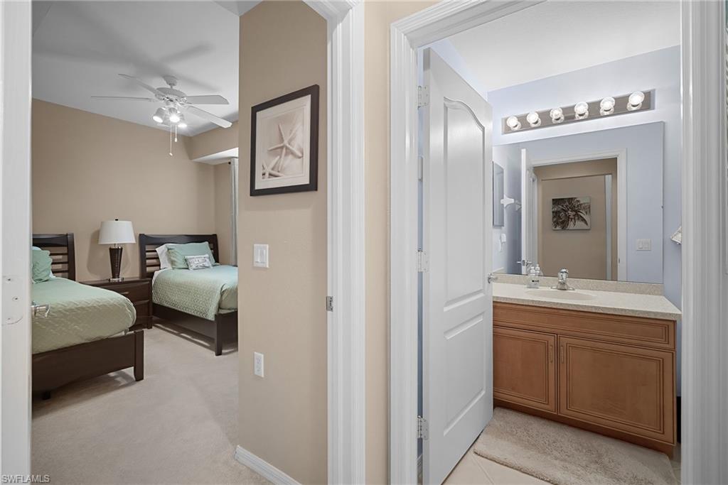 10285 Heritage Bay Boulevard, Unit 817 Naples, FL 34120 - Photo 9 of 42 a en suite bathroom with a double vanity sink and a mirror