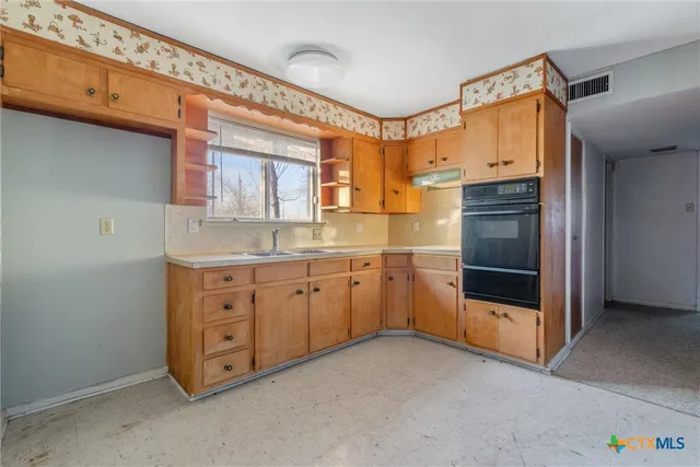 a bathroom with a granite countertop toilet sink and mirror