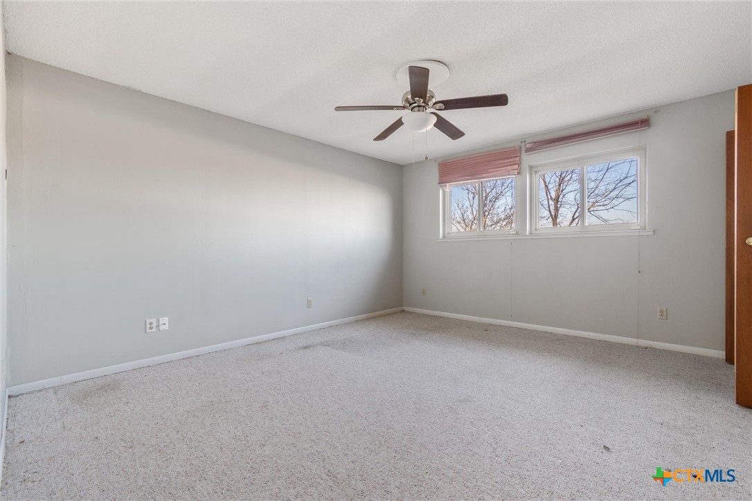 1101 Ridgeway Drive Killeen, TX 76549 - Photo 25 of 31 an empty room with windows and fan