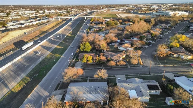 an aerial view of residential houses with outdoor space