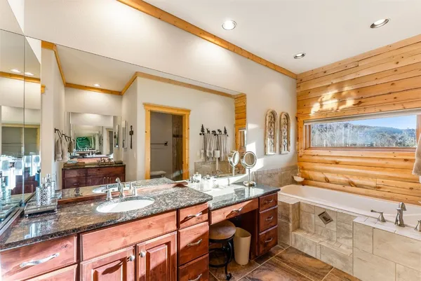 a spacious bathroom with a granite countertop sink and a large mirror