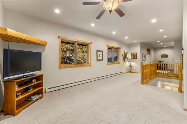 a view of a livingroom with furniture and a flat screen tv