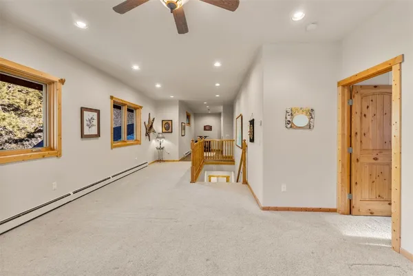 a view of a livingroom with furniture and a ceiling fan