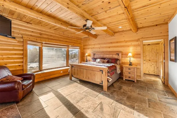 a bed room with a bed and a chair