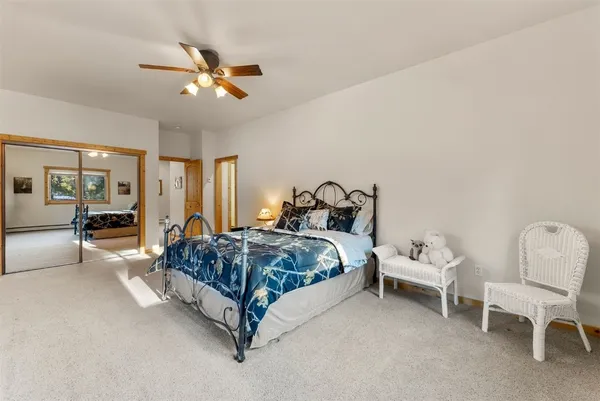 a spacious bedroom with a bed and a chandelier