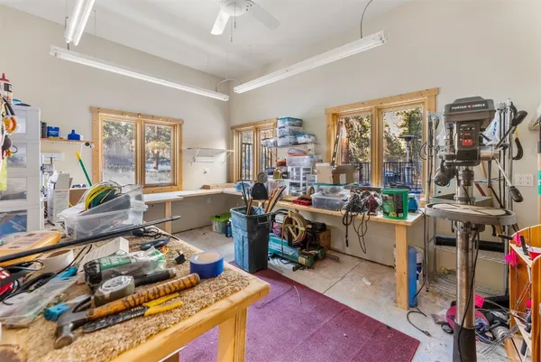 a living room with furniture a flat screen tv and a floor to ceiling window