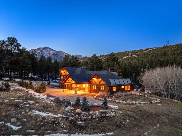 a view of a house with a yard and a mountain view