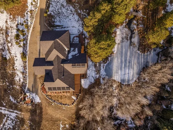 a view of a house with a yard and large tree