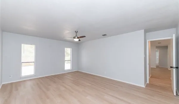 a kitchen with granite countertop a sink and a stove top oven with wooden floor