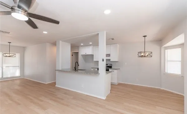 a view of a kitchen with a sink hardwood floor and a window
