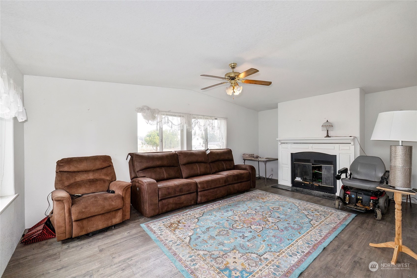 245 Griffith Farm Road Sequim, WA 98382 - Photo 14 of 33 a living room with furniture a fireplace and a table
