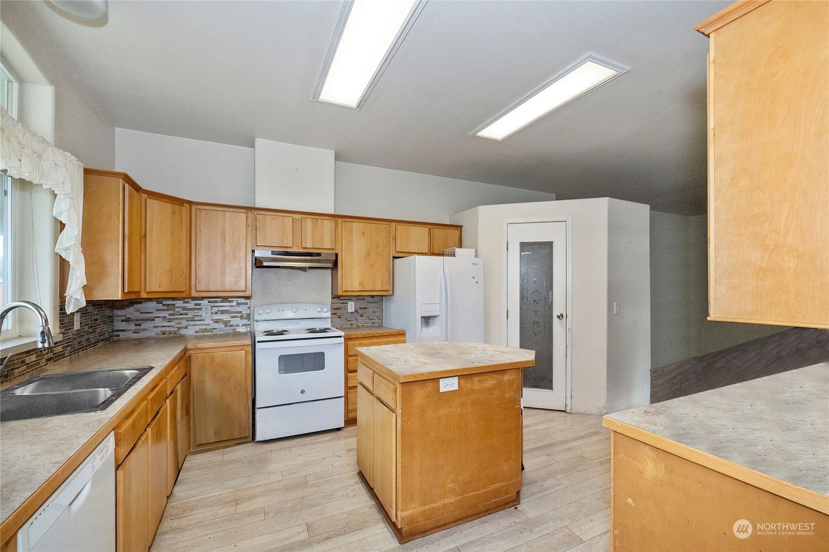 245 Griffith Farm Road Sequim, WA 98382 - Photo 16 of 33 a kitchen with a stove sink and refrigerator