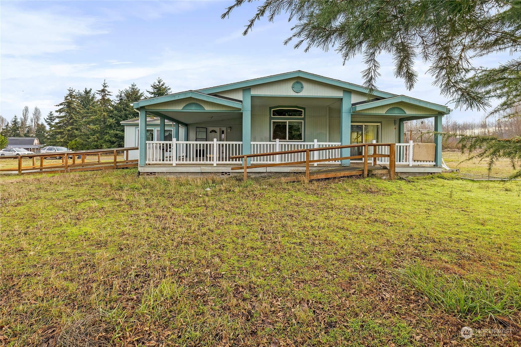 245 Griffith Farm Road Sequim, WA 98382 - Photo 2 of 33 a view of a white house with a large pool and large trees