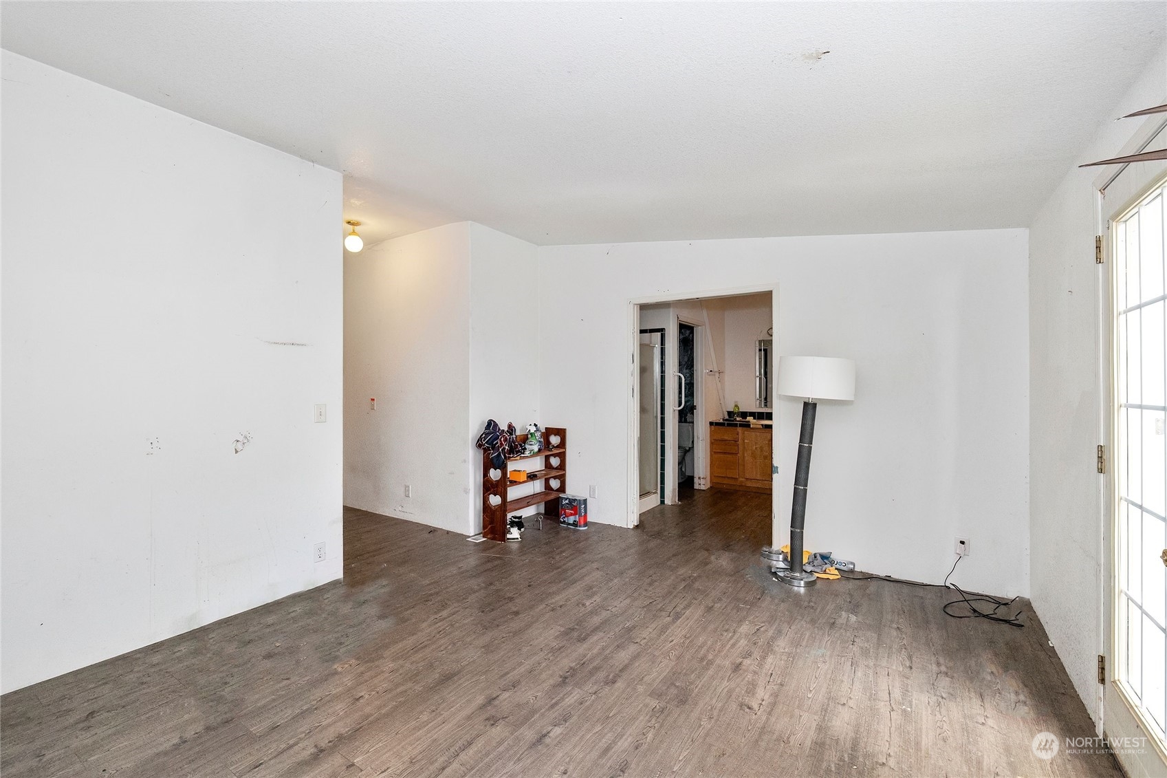 245 Griffith Farm Road Sequim, WA 98382 - Photo 24 of 33 an empty room with wooden floor and a window