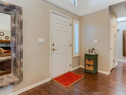 a view of a livingroom with wooden floor and a cabinet