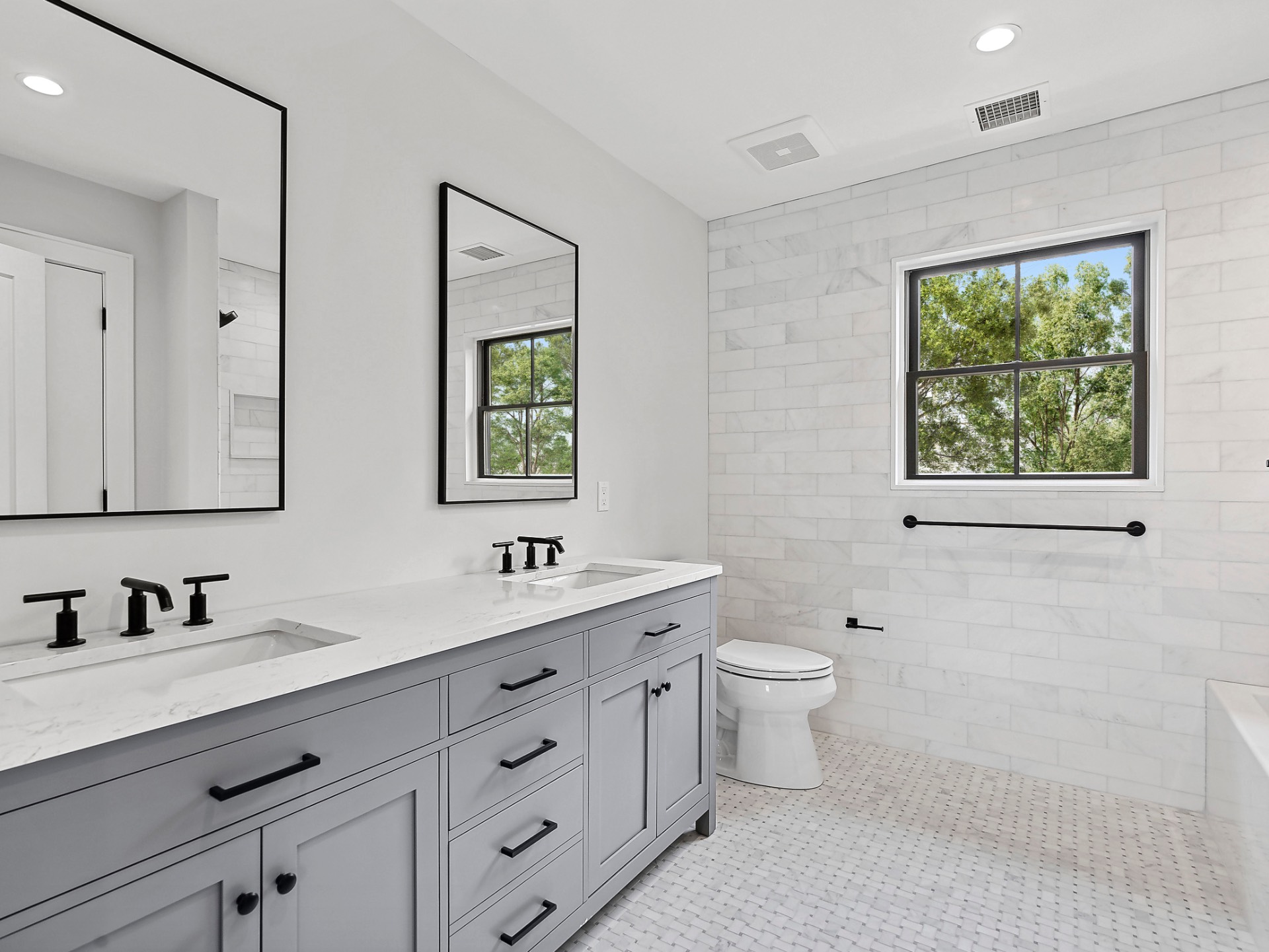 60 Kings Point Road East Hampton, NY 11937 - Photo 16 of 27 a bathroom with double sink a toilet a window and mirror