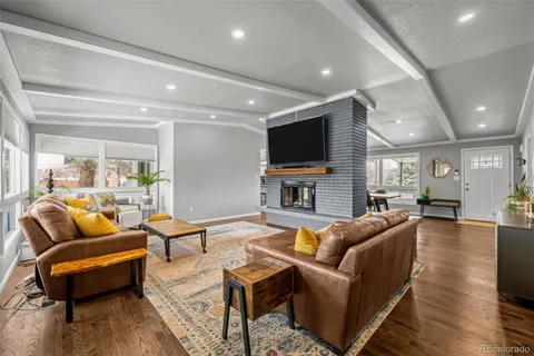 a living room with fireplace furniture and a flat screen tv