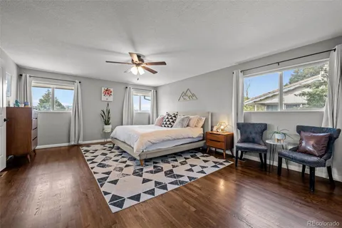 a bedroom with furniture window and wooden floor