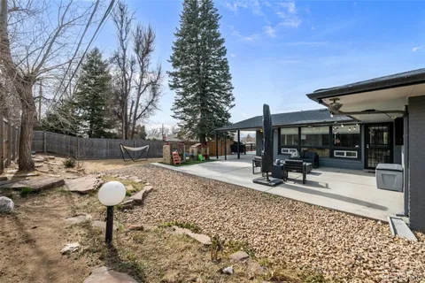 a view of a chairs and tables in the back yard of the house