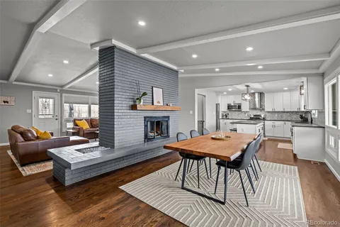 a living room with fireplace furniture and a wooden floor