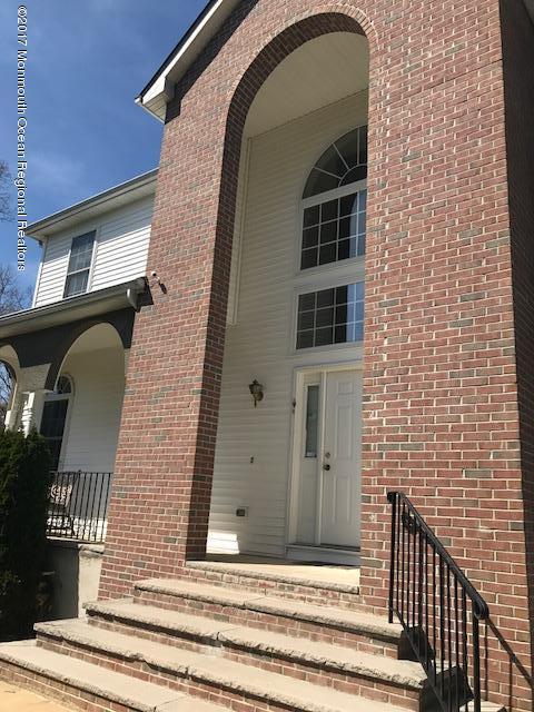 280 Aldrich Road Howell, NJ 07731 - Photo 3 of 13 a view of a brick house with large windows