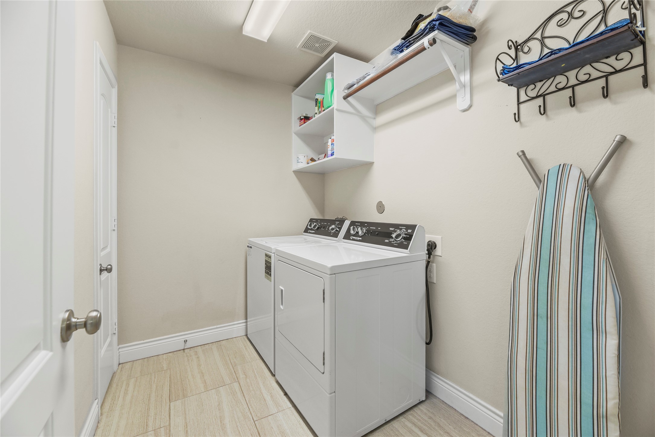 3834 Trophy Ridge Drive Spring, TX 77386 - Photo 11 of 43 a utility room with cabinets washer and dryer