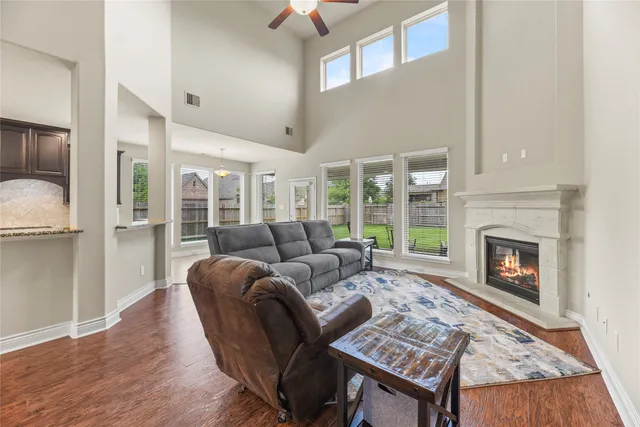 a living room with furniture a fireplace and a table