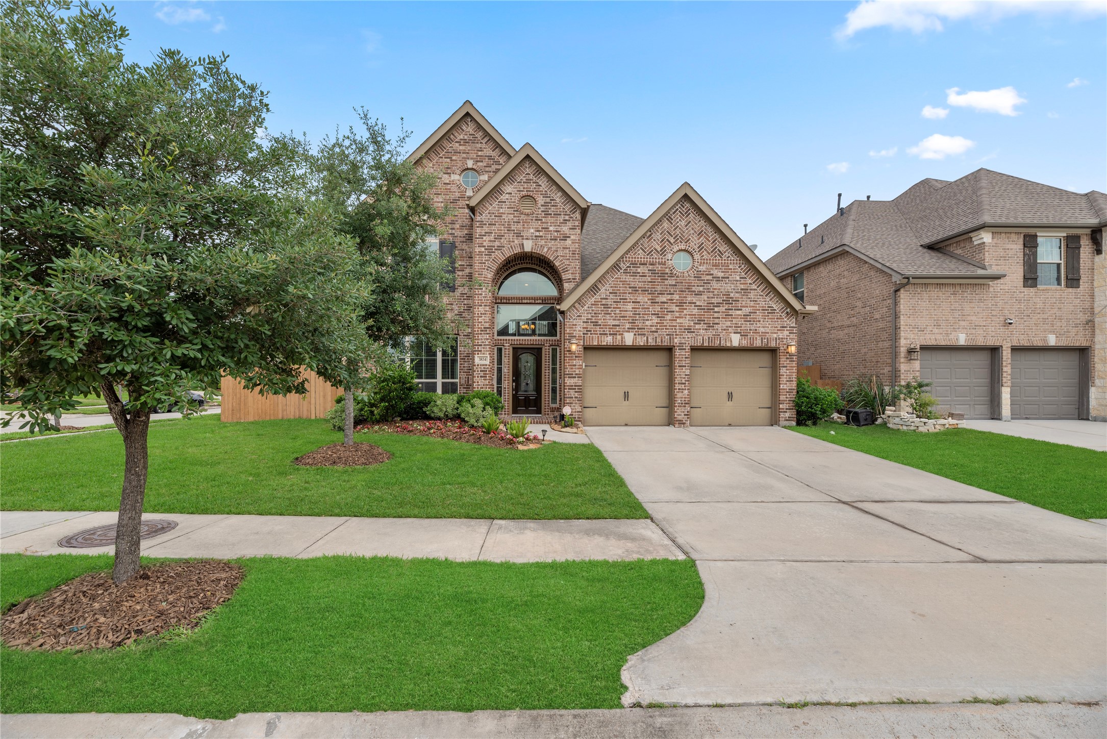3834 Trophy Ridge Drive Spring, TX 77386 - Photo 3 of 43 a front view of a house with a garden and trees