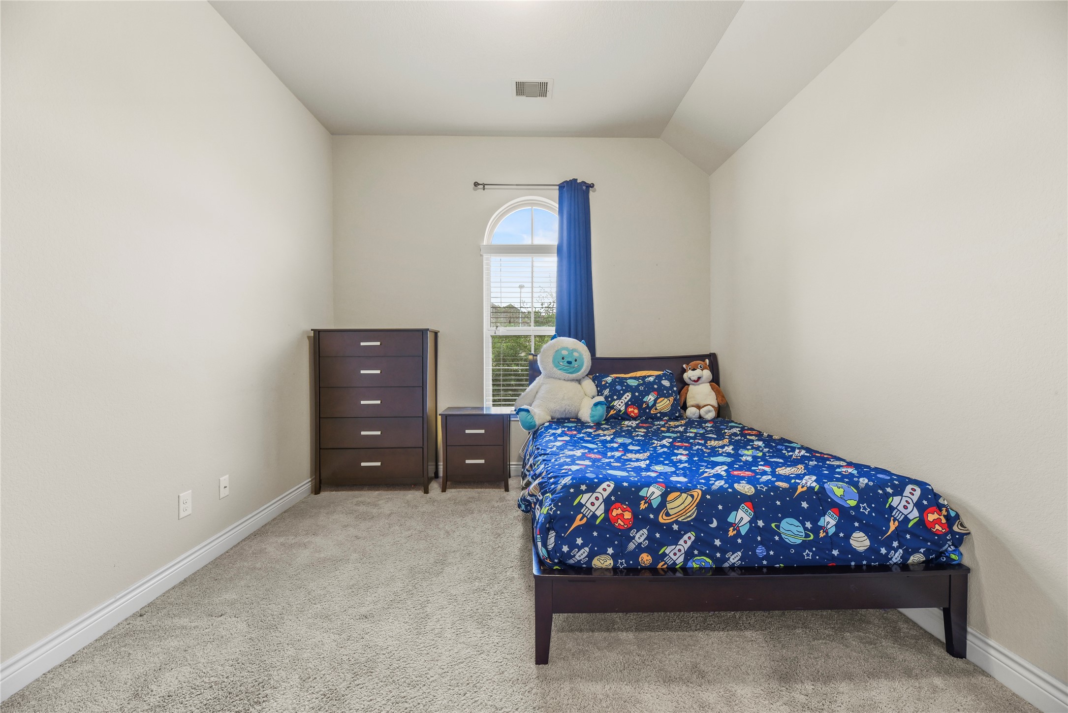 3834 Trophy Ridge Drive Spring, TX 77386 - Photo 34 of 43 a bed sitting in a bedroom next to a window and dresser