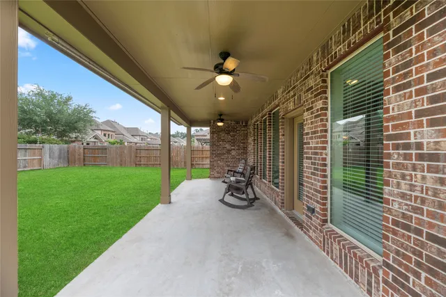 a view of a porch with furniture and garden