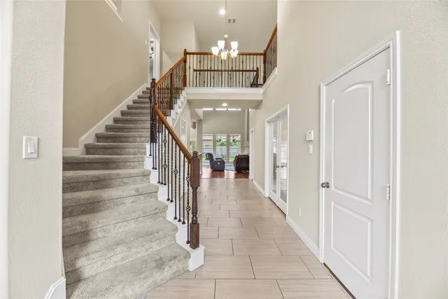 a view of entryway and hall with a front door