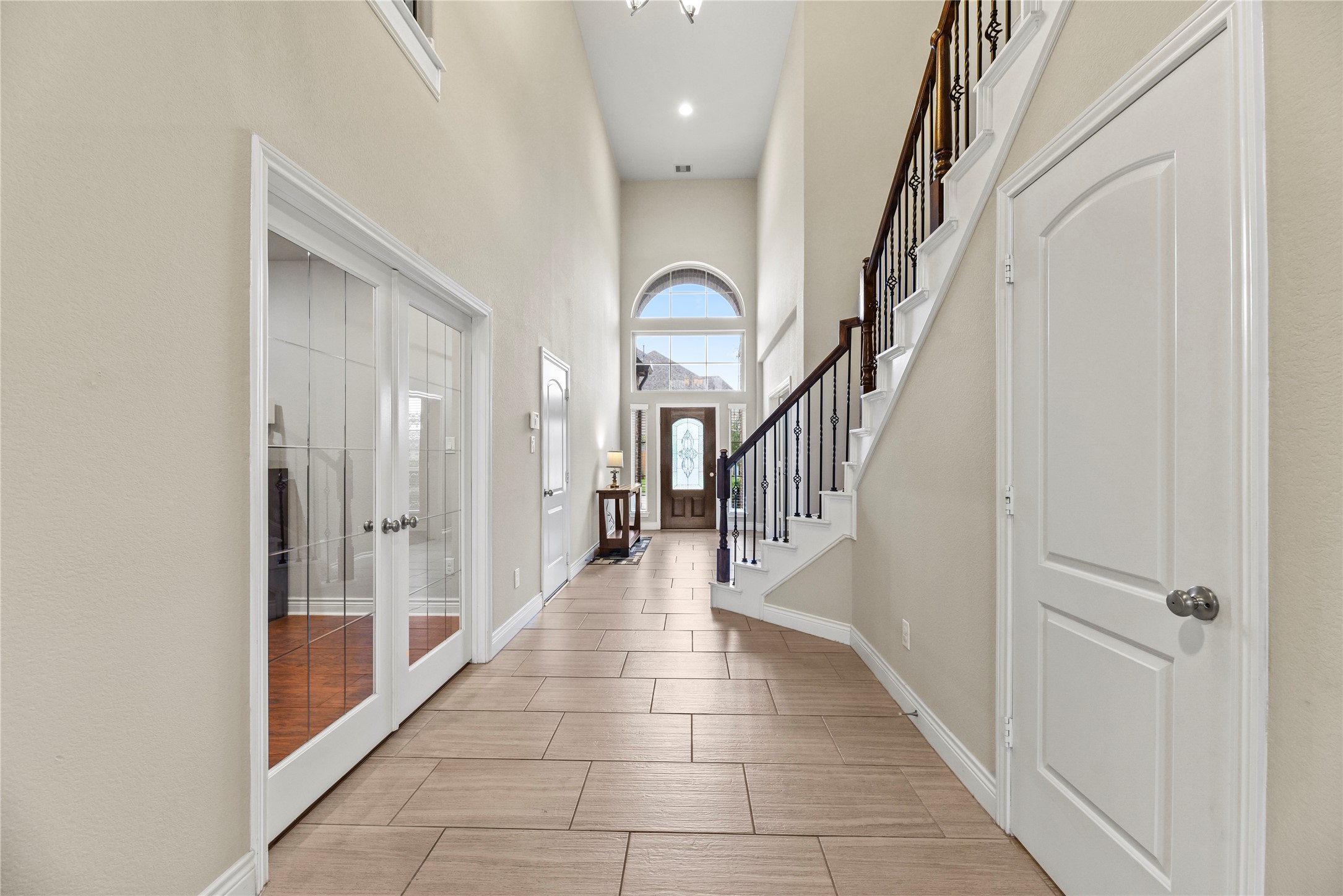 3834 Trophy Ridge Drive Spring, TX 77386 - Photo 6 of 43 a hallway with wooden floor windows and stairs
