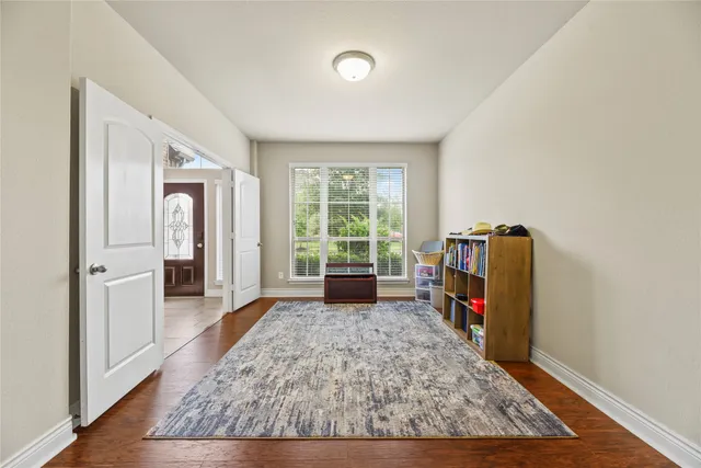 a view of a bedroom with bed and wooden floor