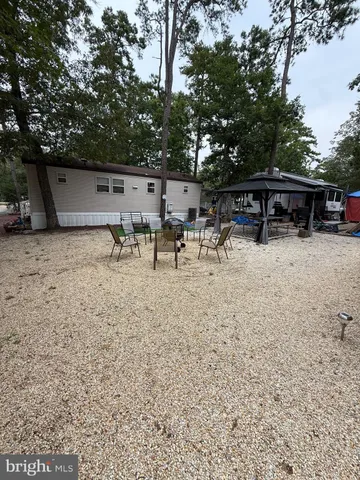 a view of a roof deck with couches under an umbrella