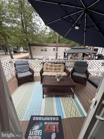 a view of roof deck with table and chairs