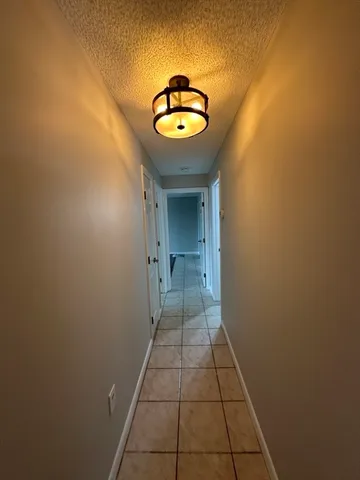 a view of a hallway with a chandelier