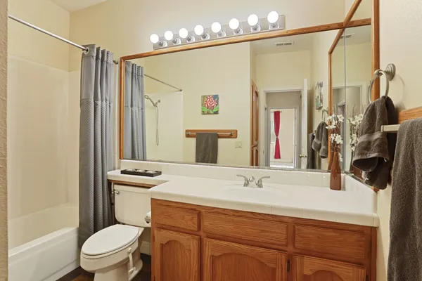 a spacious bedroom with a bed and a flat screen tv