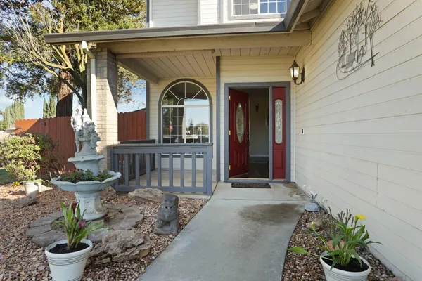 a view of a house with a small yard and flower plants