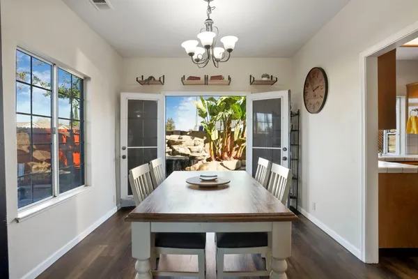 a vase of flowers sitting on a table with a fireplace