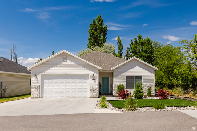 287 East 1000 North Logan, UT 84321 - Photo 2 of 41 Exterior featuring white horizontal siding and stone veneer accents