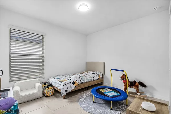 a bedroom with furniture and a chair