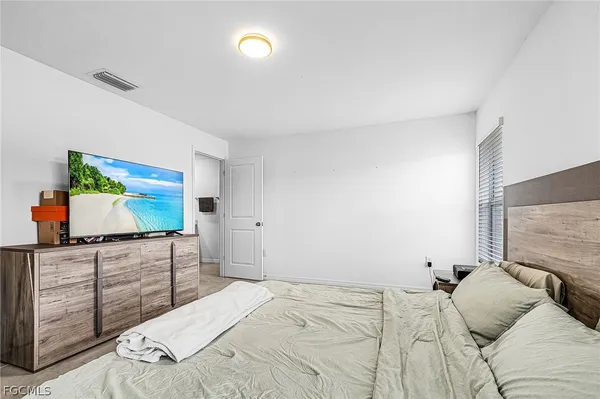 a bedroom with a bed and flat screen tv