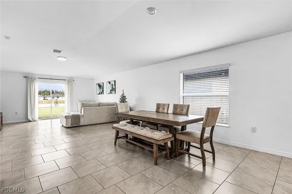 a view of a dining room with furniture and window
