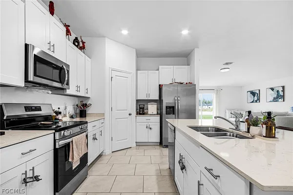 a kitchen with a sink stove and refrigerator