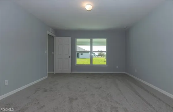 an empty room with window and outside view