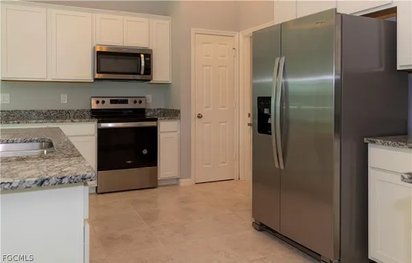 a kitchen with a refrigerator stove and microwave