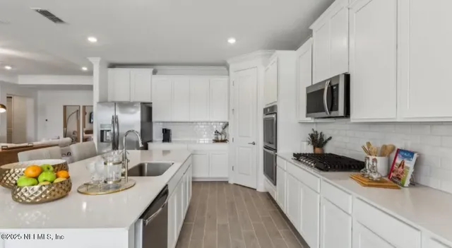 a dining room with furniture and wooden floor