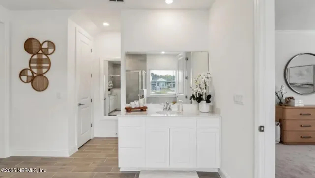 a bedroom with two beds and a large window
