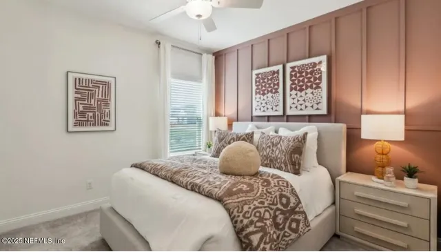 a bedroom with furniture and a large window